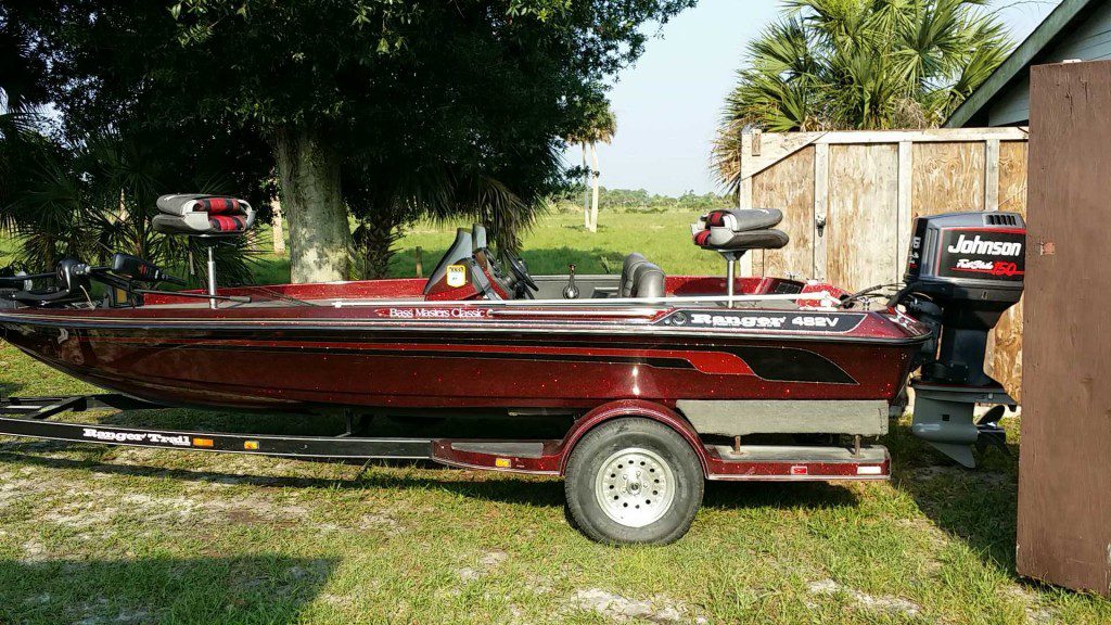 Linc Thomas's dark red bass boat hooked up to the trailer, ready for the fishing trip his truck almost couldn't make