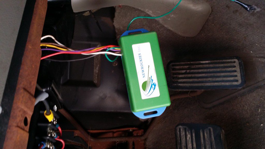 The NEWROCKIES PRO Module installed in the driver's footwell of Linc's 1999 GMC 1500, near the pedals