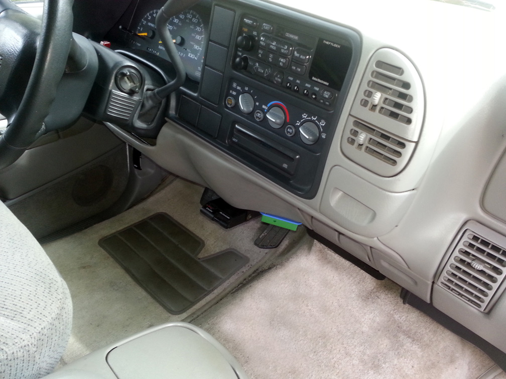 The NEWROCKIES PRO Module mounted with screws to the interior trim of Dale Novak's Suburban, with wiring visible below