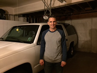 Mark Gilmore standing next to his Suburban