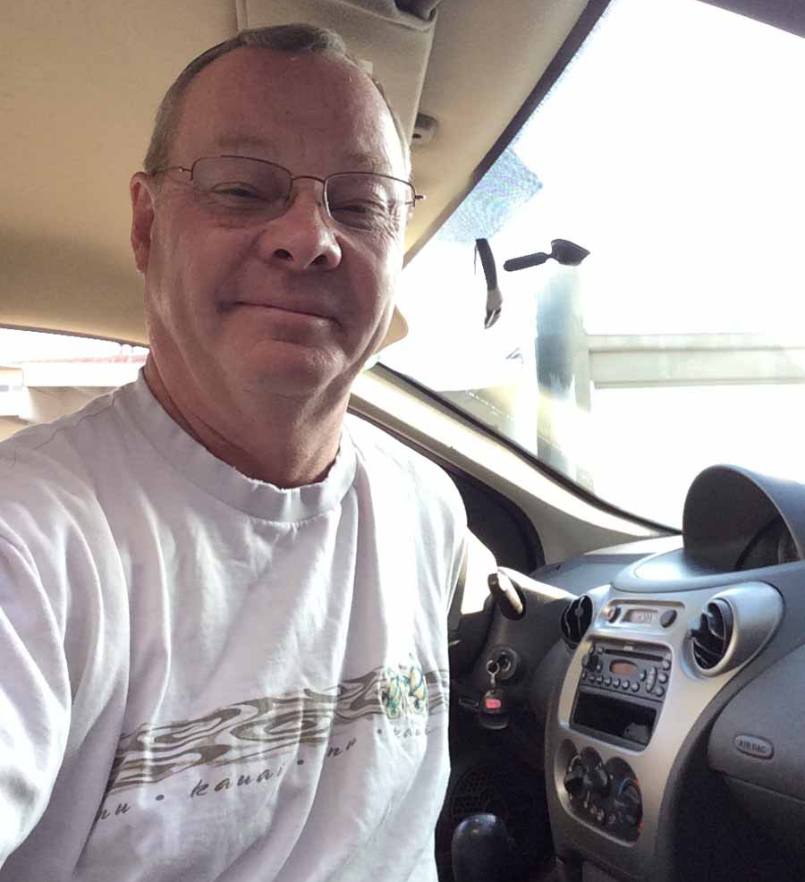 Mike Rutledge smiling behind the wheel of his 2004 Saturn Ion after fixing the SECURITY light for good