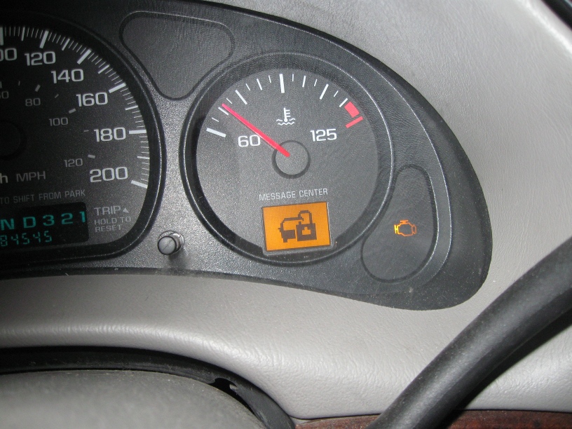 Chevrolet Impala instrument cluster showing an illuminated security warning icon and check engine light
