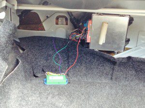 The NEWROCKIES PRO Module installed on the carpet near the theft deterrent module in Jeffrey Aragon's Cadillac Fleetwood