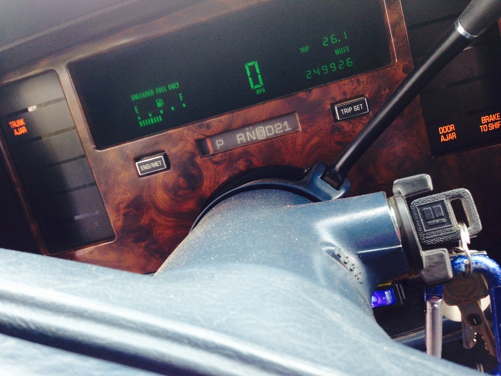 Dashboard of Jeffrey Aragon's 1993 Cadillac Fleetwood showing 249,926 miles on the odometer, keys in the ignition, after the NEWROCKIES PRO Module fix