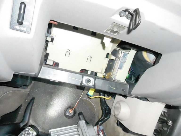 NEWROCKIES PRO Module tucked into the factory TDM location in a 1996 Oldsmobile Aurora
