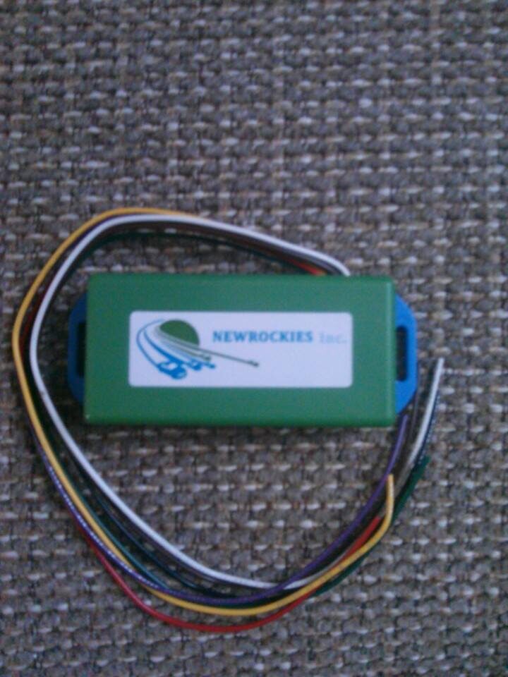 The green NEWROCKIES PRO Module with its multi-coloured wires before installation
