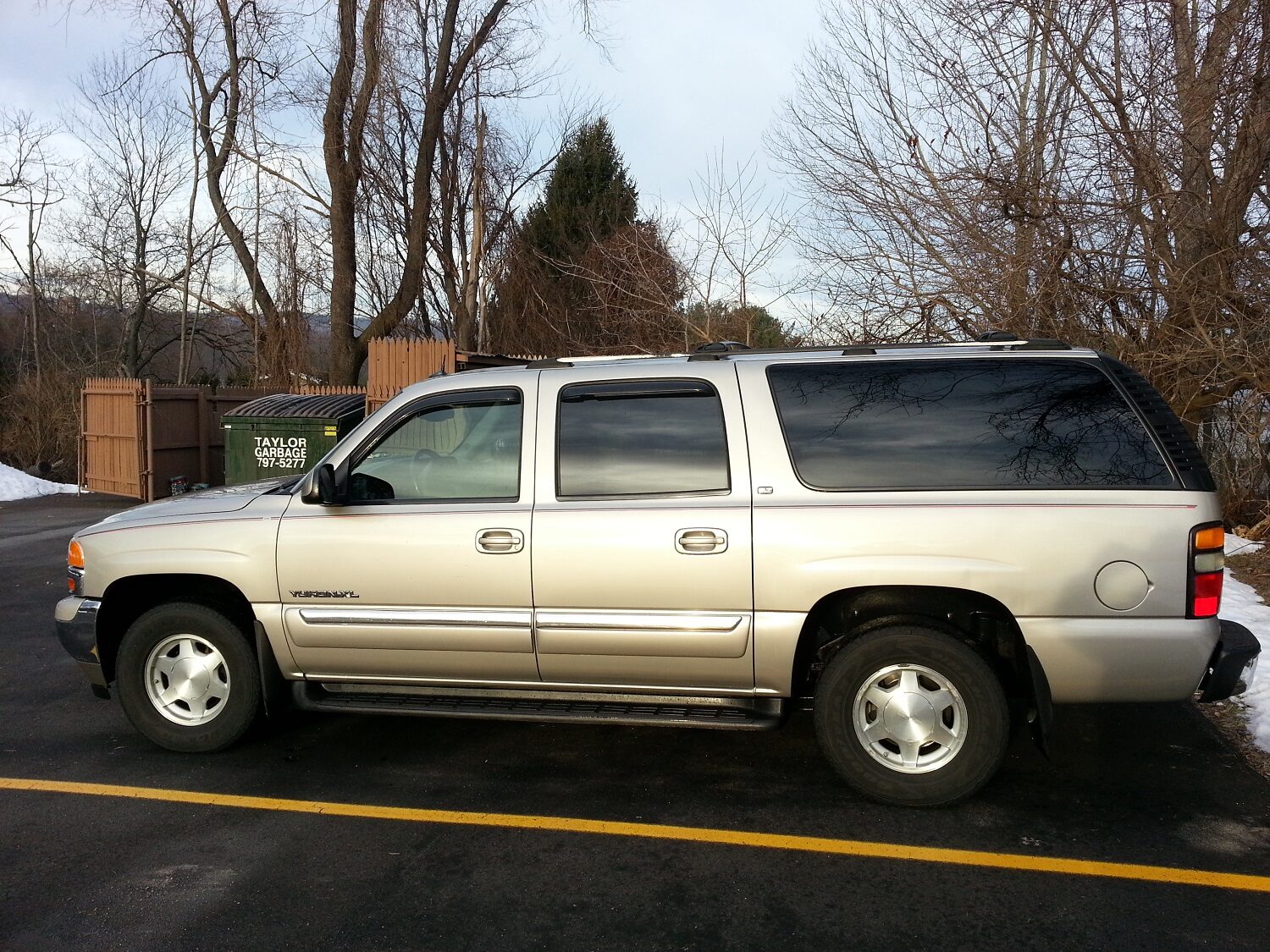 The silver GMC Yukon XL parked on pavement