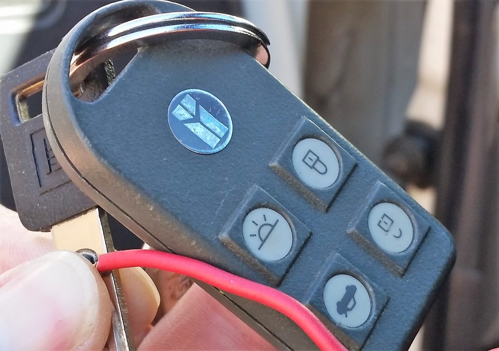 A set of Oldsmobile Toronado keys with a black aftermarket remote start fob