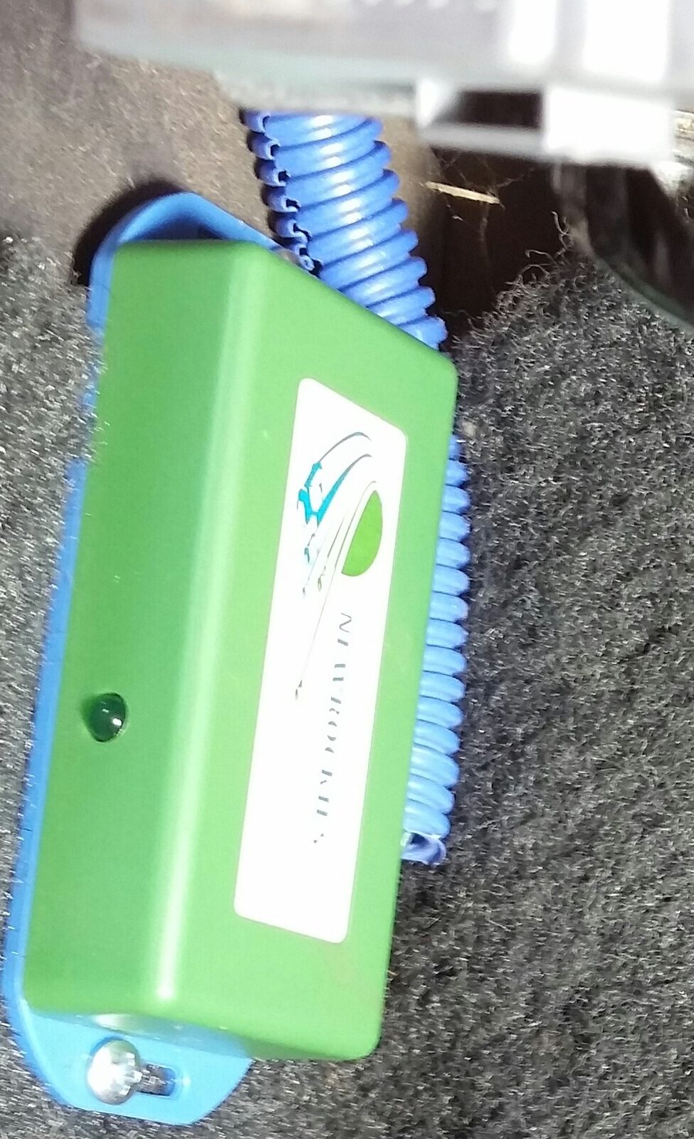 The green NEWROCKIES PRO Module mounted on a blue base beside blue corrugated tubing on the Toronado floor