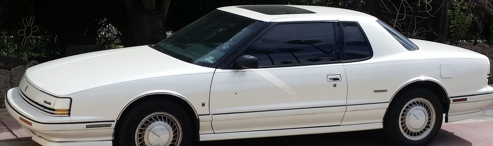 White two-door 1992 Oldsmobile Toronado parked outdoors