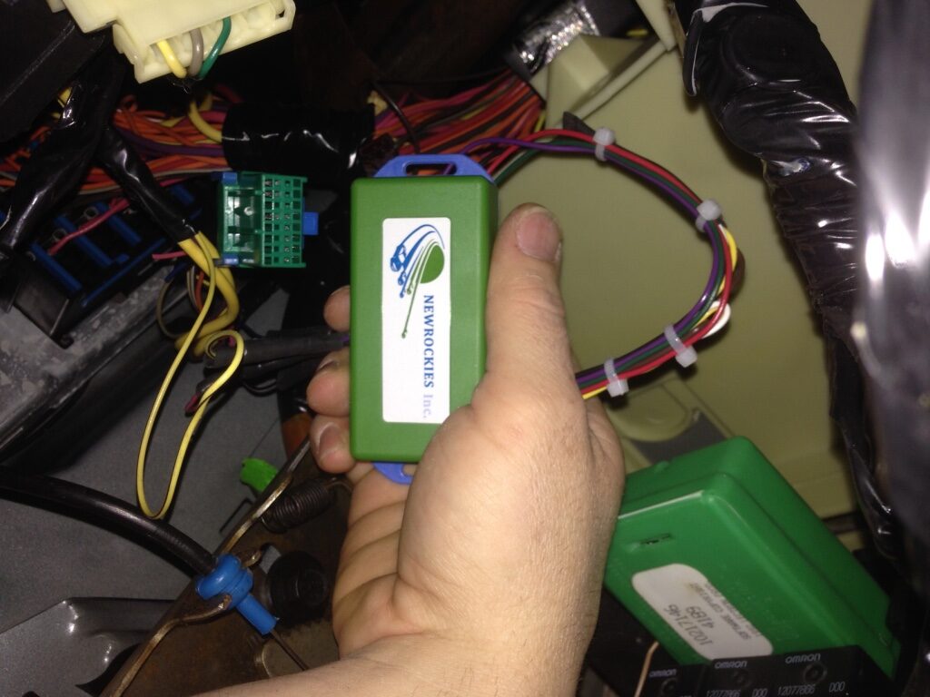 The green module, relays and wiring where the old aftermarket alarm lived