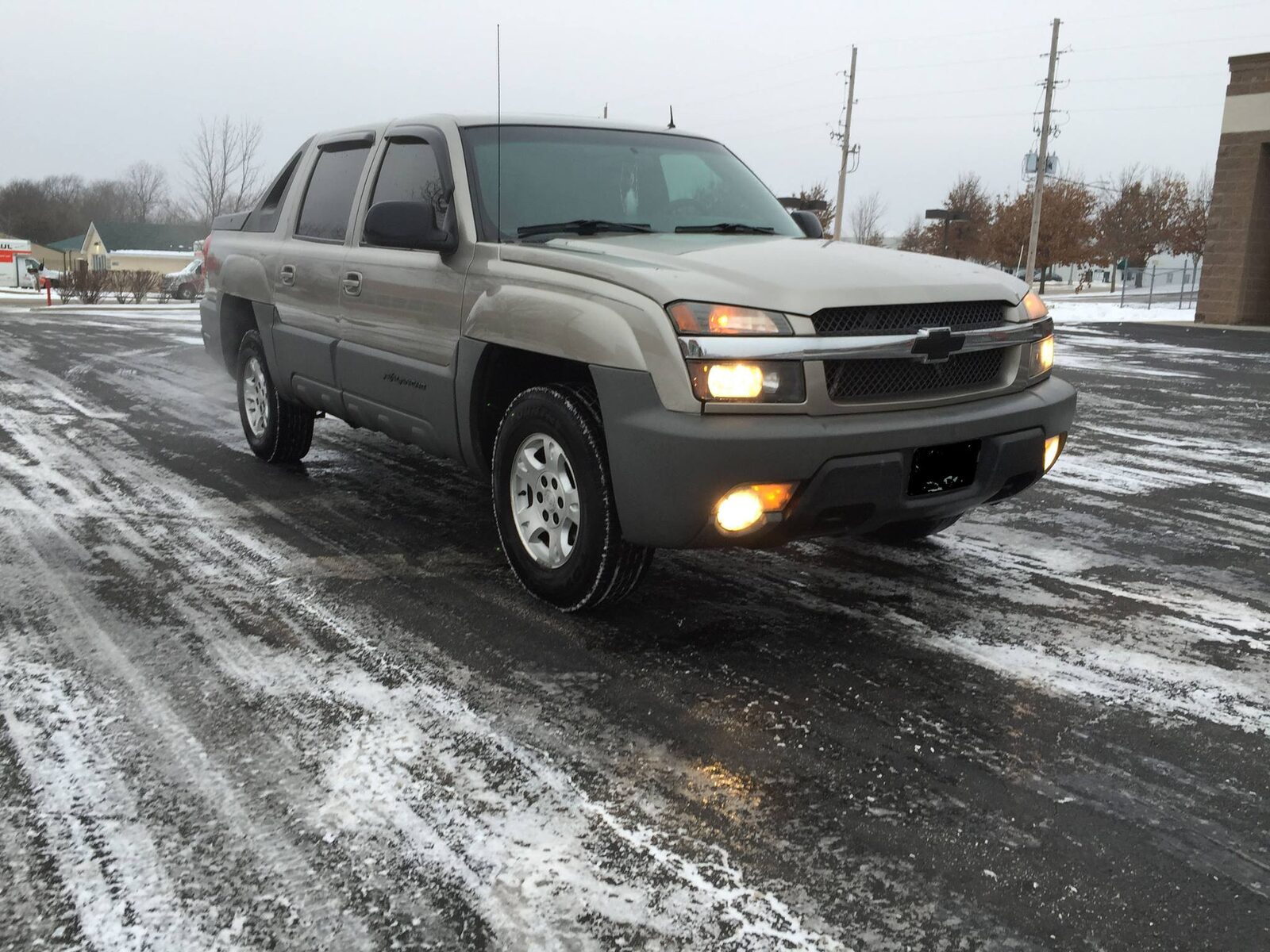 Jerrald's tan Chevrolet Avalanche parked in a snowy lot