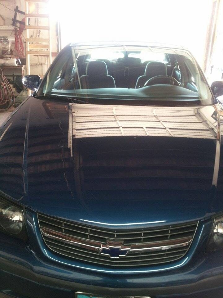 A dark blue Chevrolet Impala in the Excel Automotive workshop in Tampa