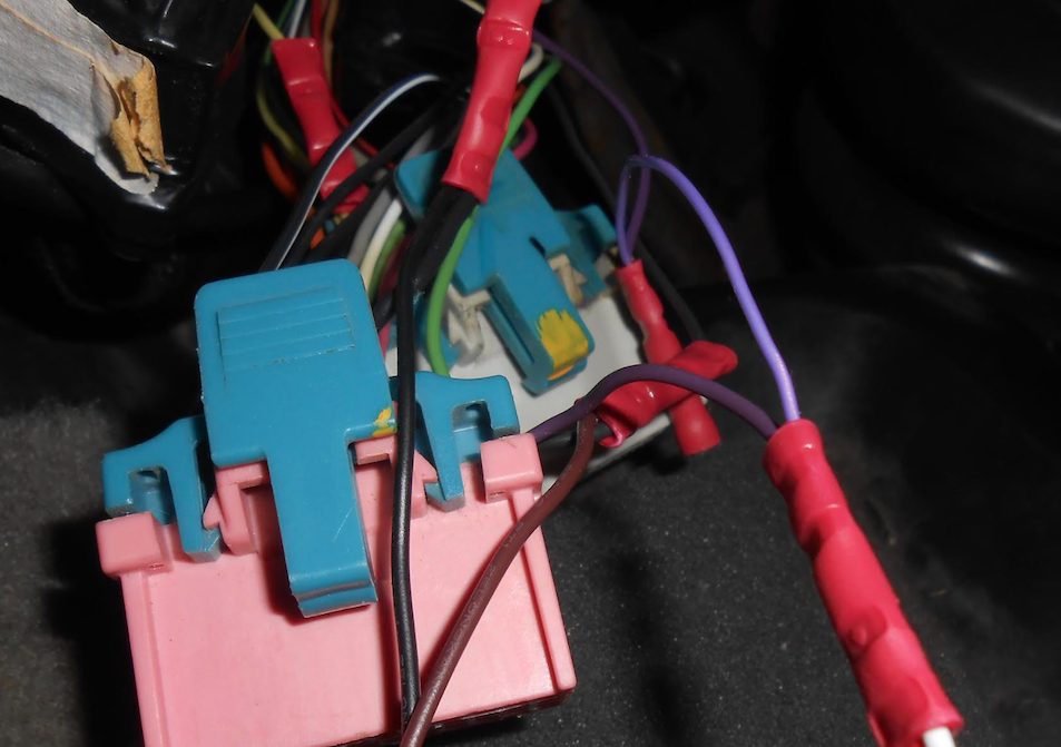 Multi-coloured Impala wires attached to pink and blue connectors with red crimp splices