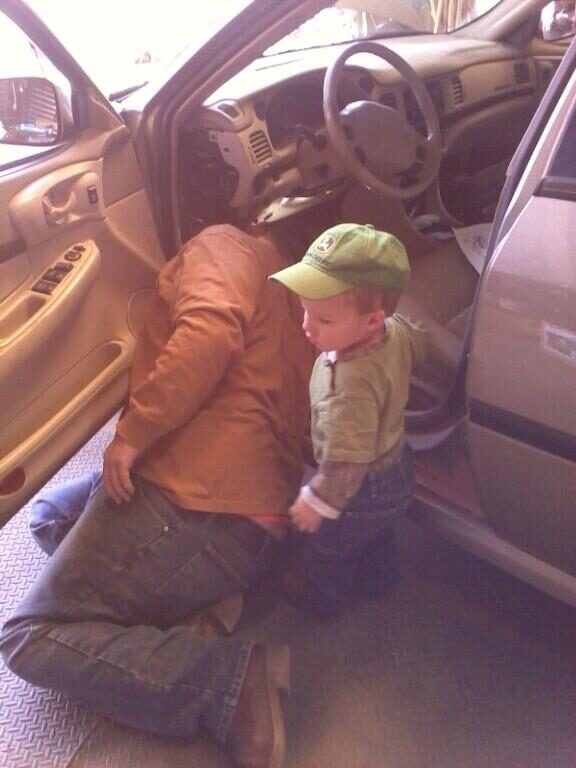 Matt leaning into the Impala with his young son beside him