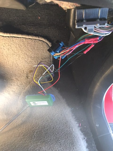 Exposed wiring, connectors and the green NEWROCKIES PRO Module on the Camaro floorboard