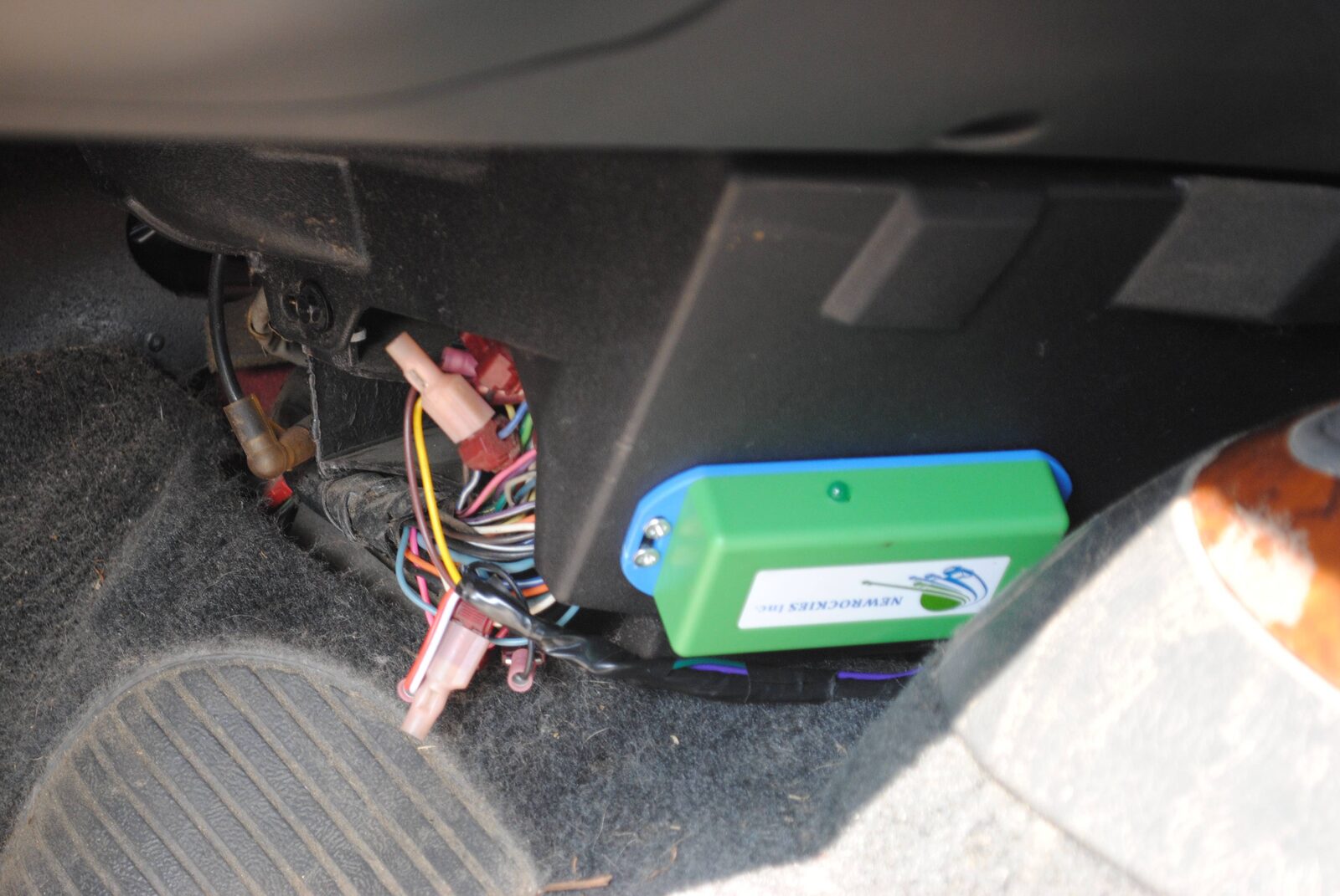 The green NEWROCKIES module and wiring under the Bravada dashboard