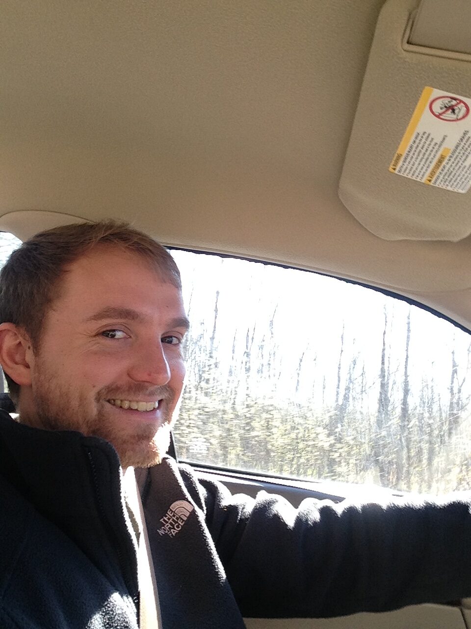 Steve smiling in the driver's seat of his 2004 Impala