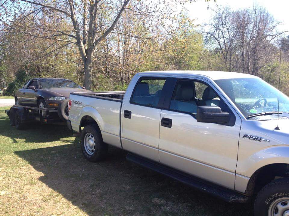 The silver pickup and flatbed trailer carrying the Riviera home, 600 miles from Kentucky